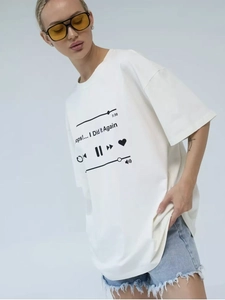 Detail of white cotton oversized T-shirt with black music player graphic and song text
