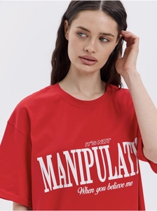 Detailed close-up of white letter print on a premium bright red cotton short sleeve T-shirt