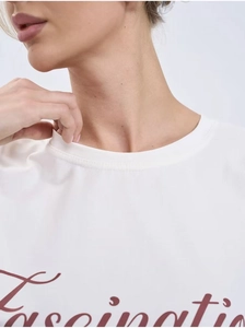 Close-up of the ribbed neckline and red Fascinating print on a white cotton t-shirt