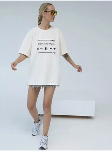 Close-up of oversized cotton T-shirt featuring a black music player print and dropped shoulders
