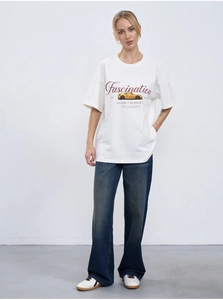 Detail of white cotton T-shirt featuring vintage car print and Fascination lettering