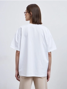 Rear view of an oversized white short-sleeve cotton T-shirt with dropped shoulders