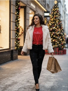 Detail of red cotton t-shirt with text print layered under a white faux fur jacket