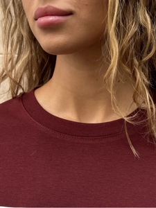 Close-up of the round neckline and refined stitching on this burgundy women's cotton t-shirt