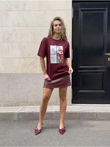 Detail view of burgundy cotton T-shirt with 'mon chéri' print and leather mini skirt