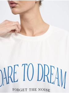 Detail of Dare to Dream slogan print on white cotton T-shirt with ribbed crew neck