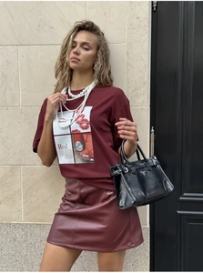 Close-up of wine red t-shirt with artistic vintage car print and pearl necklace