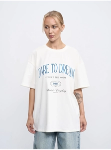 Detailed view of Dare to Dream slogan print on a white oversized cotton T-shirt