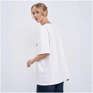 White oversized cotton t-shirt with side red number print shown from a back profile view
