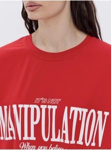 Detail of red cotton T-shirt featuring bold white 'IT'S NOT MANIPULATION' graphic print