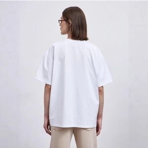 Back view of a white oversized crewneck T-shirt with dropped shoulders in pure cotton