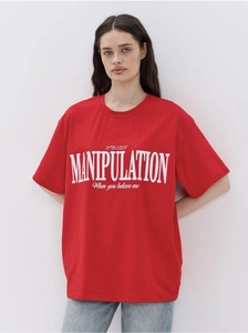 Close-up of red cotton t-shirt featuring bold white slogan print and relaxed fit style