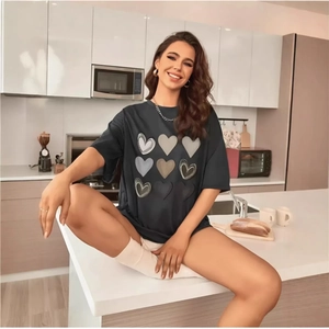 Women's drop shoulder black T-shirt with nine-grid heart print in a modern kitchen setting