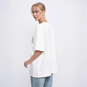 Oversized white cotton T-shirt with blue letter print on the side, street style look