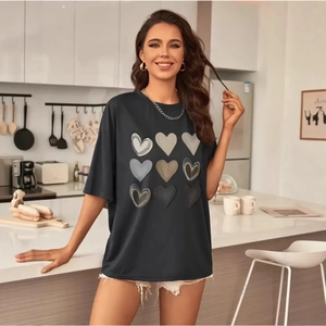 Black oversized T-shirt for women featuring a grid of nine artistic heart prints