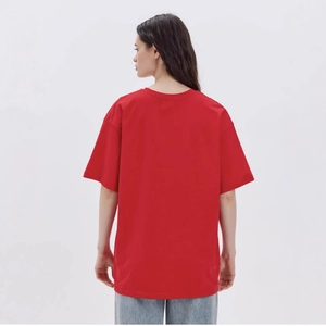 Back view of an oversized red cotton T-shirt featuring a relaxed drop shoulder fit for women