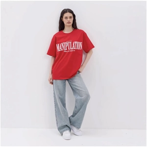 Oversized red cotton T-shirt with white graphic print paired with loose jeans