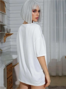 Detail of white drop-shoulder t-shirt showing its relaxed fit and soft fabric texture
