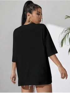 Side view of oversized black cotton T-shirt with drop shoulder and relaxed mid-length fit