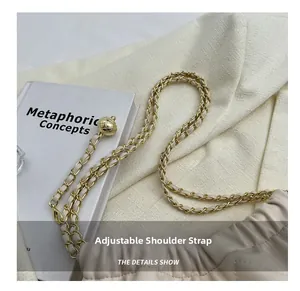 Detail of adjustable gold ball buckle on beige quilted leather shoulder bag chain