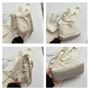 Detail view showing beige quilted bucket bag with gold chain strap and metal accents