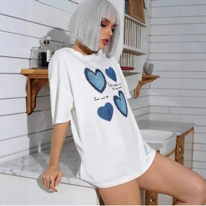 Women's white cotton oversized T-shirt featuring blue heart patchwork print and text