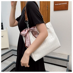 Quilted off-white tote bag with brown straps and pink heart silk scarf detail on shoulder
