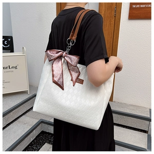 White quilted tote bag with brown straps and silk scarf detail shown on model