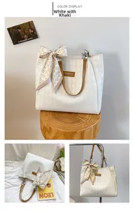 Detailed view of white quilted tote bag with brown straps and decorative heart scarf