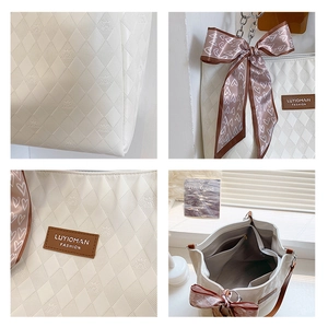 Detail of white tote bag with quilted texture, logo pattern and silk scarf decor