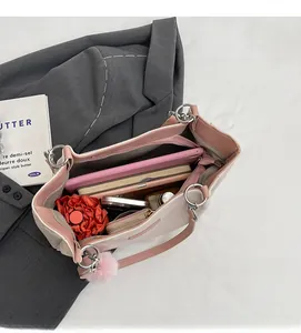 Spacious interior of quilted tote bag holding a tablet, umbrella, and accessories
