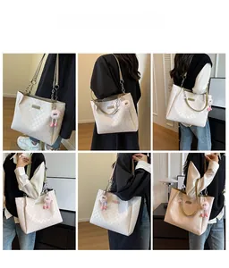 Detailed views of a white checkered tote bag with a pink pompom charm and chain strap