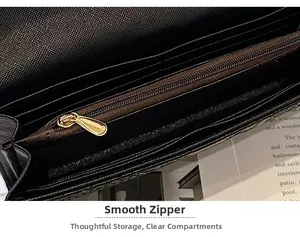 Detail of black faux crocodile wallet featuring a smooth gold zipper and card slots