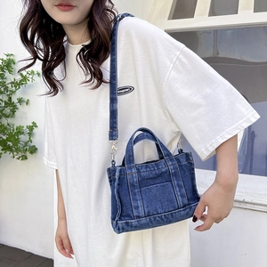 Deep blue denim multi-functional crossbody bag with adjustable strap and handles