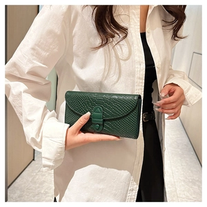 Detail of green crocodile pattern embossed texture on elegant women's small wallet