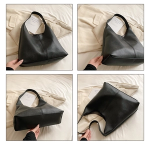 Detail view of large black lychee leather hobo bag showing texture and stitching details