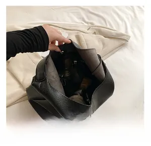 Internal view of large black pebble leather tote bag showing spacious capacity and zip pocket