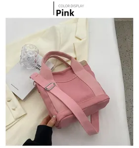 Pink canvas tote bag with shoulder strap shown in a lifestyle aesthetic setting
