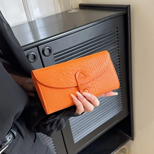Chic orange faux crocodile leather wallet for women with flip closure and stylish buckle