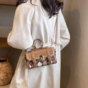 Vintage brown leather and plaid Boston bag for women with gold clasp in a stylish setting