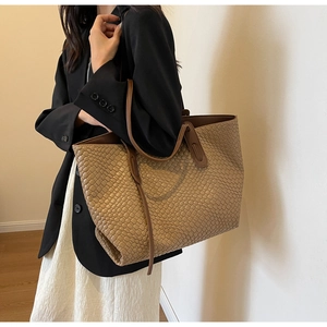 Detail of retro woven texture and spacious interior of the khaki leather tote bag