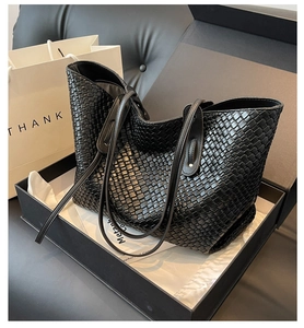 Unboxing display of large black woven tote bag with premium gift box and bag packaging