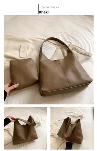 Detailed close-up of khaki textured leather tote bag and matching inner pouch set
