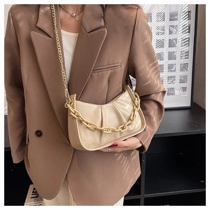 Detail of off-white pleated cloud bag with stylish chain straps and matte faux leather texture