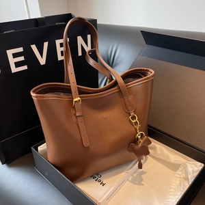 Brown leather tote bag with elephant charm in luxury gift box with dust bag