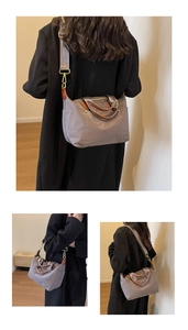 Three-view display of grey nylon shoulder bag with brown leather straps and gold metal buckles