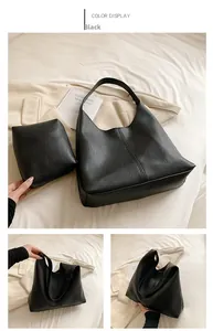 Detail view of black litchi grain leather tote bag set including a matching pouch