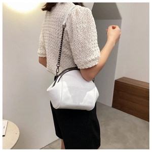 Modern white crossbody shell bag with cross-stitch pattern and black nickel chain