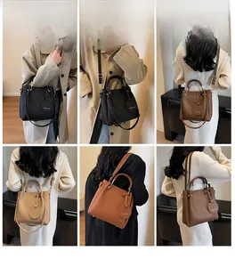 Detail view of stylish textured leather bucket bag with top handles and shoulder straps