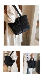 Detail of black quilted tote bag featuring shimmering glitter finish and long shoulder straps